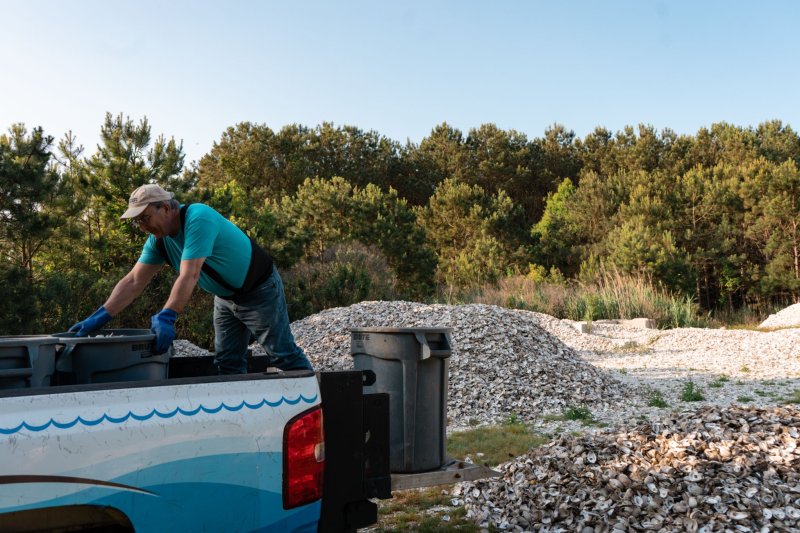 Oyster shells collected from local restaurants are used for Delaware Center for the Inland Bays habitat restoration projects. Unloading shells in the CIB yard is Jack Gazda, shellfish project specialist. SUBMITTED PHOTO